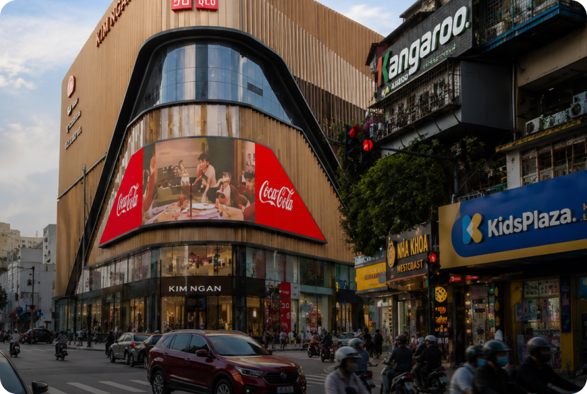 Curved Coca-Cola LED billboard on a shopping mall façade in Vietnam