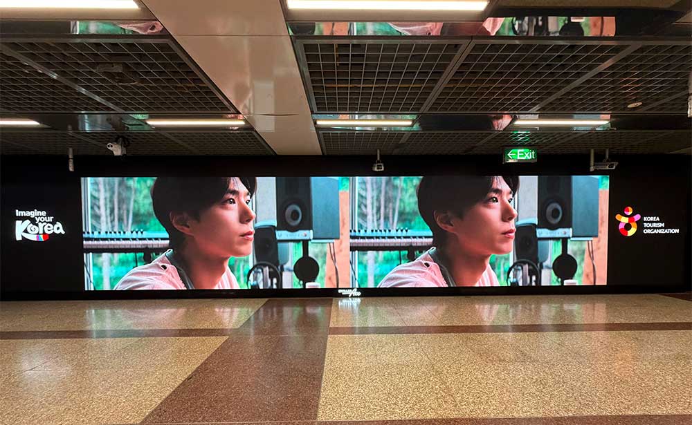 Imagine Your Korea tourism campaign on a wide indoor LED wall in Singapore