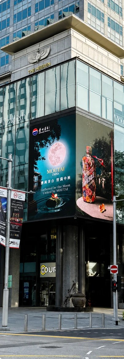 Vertical LED screen on a commercial building corner in Singapore